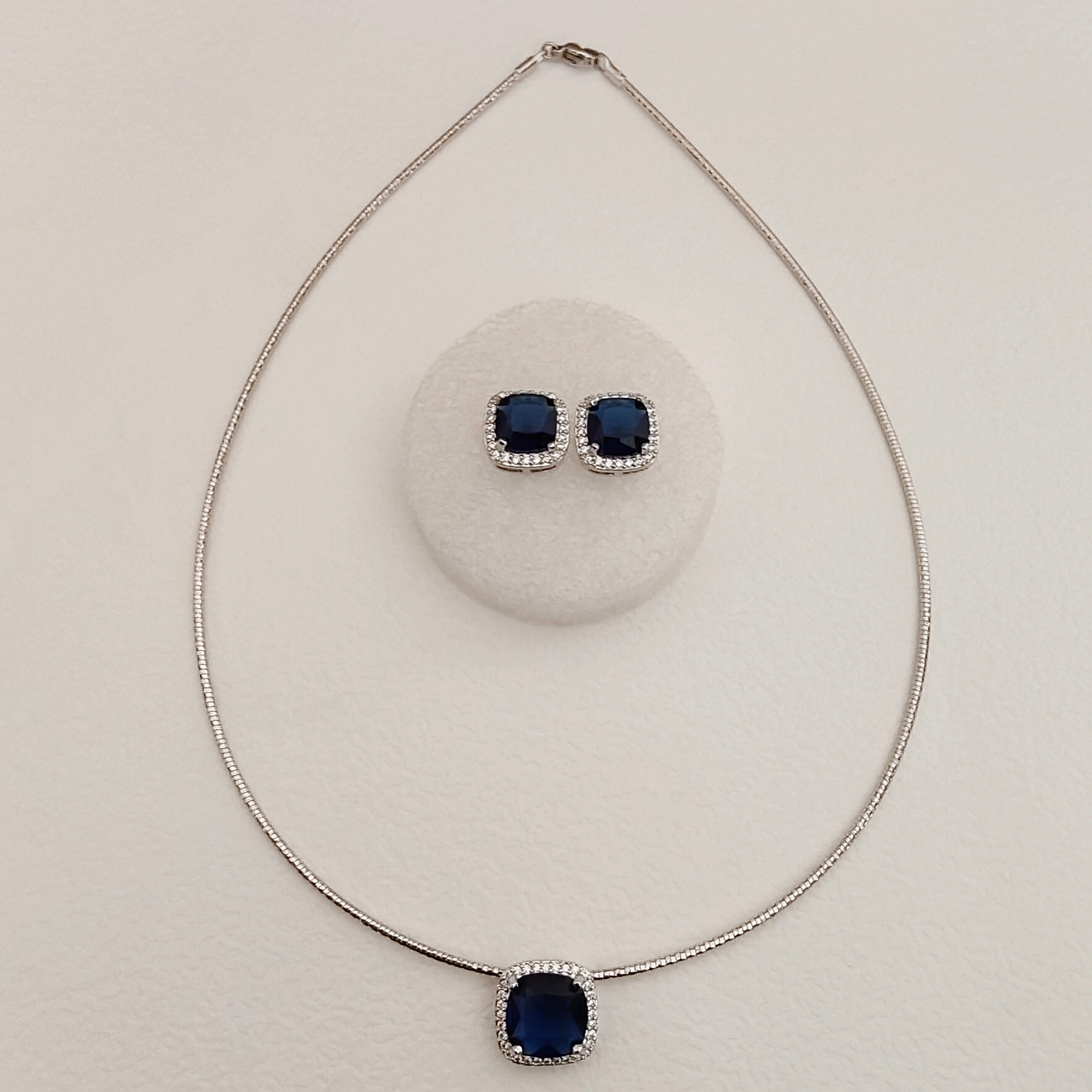 Solitaire stiff silver set pendant set